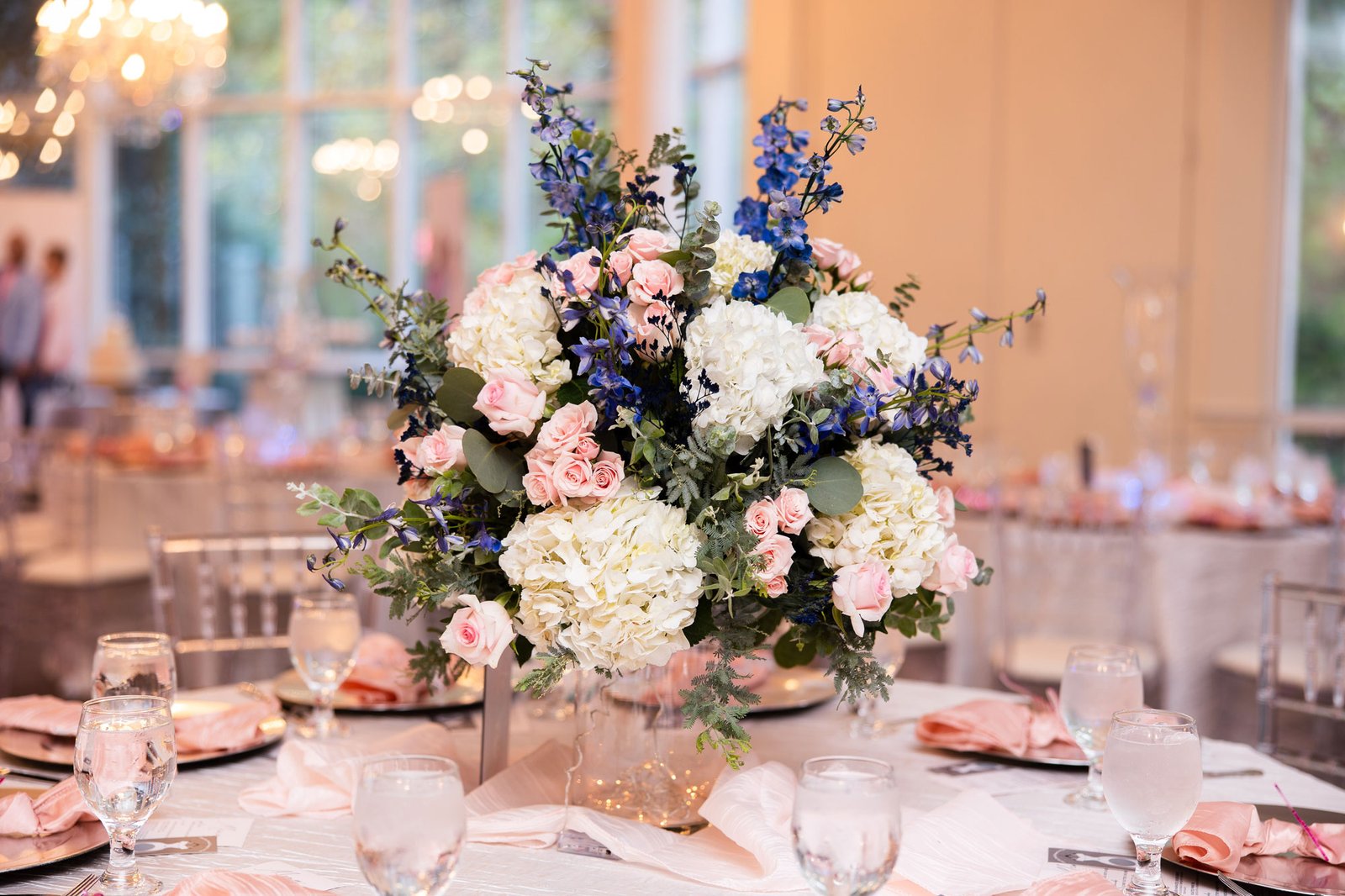 Luxurious floral centerpiece with blush and white roses at Ashton Gardens, Atlanta, GA.