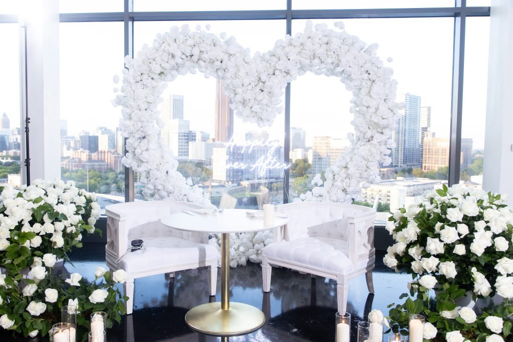 Heart-shaped floral backdrop with "Happily Ever After" neon sign, designed for a luxury reception in Atlanta.